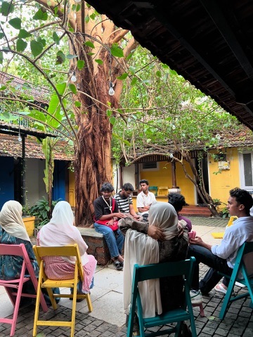 Kifayat members gathered in an outdoor courtyard